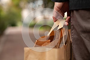 Plastic free shopping concept, hand holding paper bags