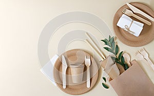 Plastic free and zero waste concept. Disposable paper tableware cups, plates, wooden forks, knives, spoons and bamboo straws on