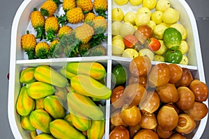 Plastic fruits on model supermarket shelf. Children pay toys