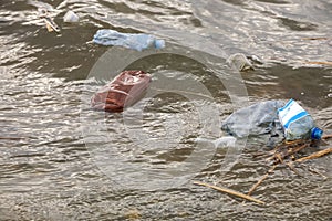 Plastic garbage floating in river. Environment pollution problem