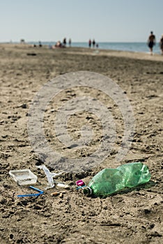 Plastic garbage left on a sandy beach.