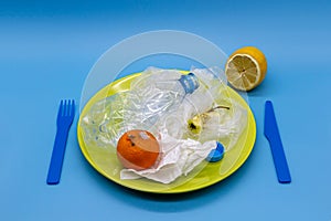 Plastic garbage on a plate, concept of junk unhealthy food, bad food quality