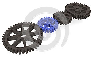 Plastic gear between metallic gears on white