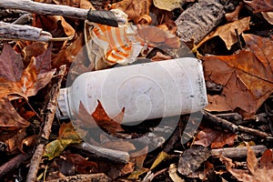 Plastic and glass bottles thrown away and left in nature, pile of garbage. Ecological, ecology, recycling industry.