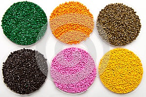 The plastic granules. Dye for polypropylene, polystyrene granules into a measuring container