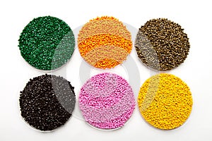 The plastic granules. Dye for polypropylene, polystyrene granules into a measuring container.