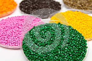 The plastic granules. Dye for polypropylene, polystyrene granules into a measuring container photo