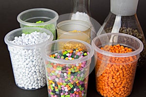 Plastic granules in a measuring container and test tubes in the laboratory. Plastic pellets. Plastic Raw material . BPA FREE photo