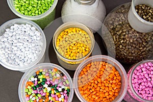 Plastic granules in a measuring container and test tubes in the laboratory. Plastic pellets. Dyes for plastic, polypropylene,