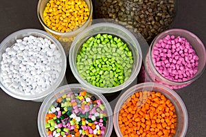 Plastic granules in a measuring container and test tubes in the laboratory. Plastic pellets. Dyes for plastic, polypropylene,