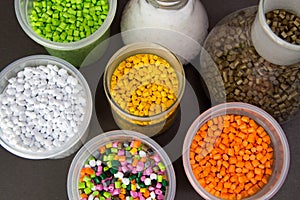 Plastic granules in a measuring container and test tubes in the laboratory. Plastic pellets. Dyes for plastic, polypropylene,