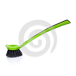 Plastic green brush with felted bristles for cleaning debris isolated on white background. Household products.