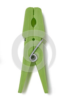 Plastic green clothes peg on white background