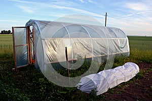 Plastic greenhouse hothouse on field in farm