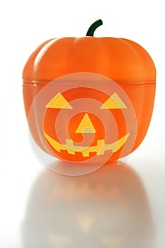 Plastic halloween pumpkin, white background