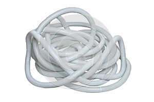 Plastic hose isolated. Close-up of a disorderly bunch of light gray industrial flexible plastic corrugated pipe for electrical