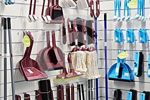 Plastic household brushes, scoops and mops in store