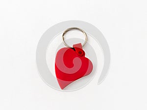 Plastic key ring breloque in the shape of a red heart on a white background