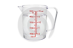 Plastic kitchen measuring cup filled with water photo