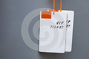 Plastic labels or tag showing the word `VIP Ticket` on gray background. with copy space on the left