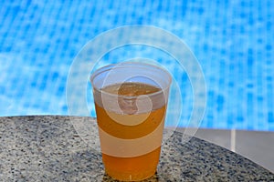 Plastic lager cup by the pool