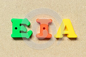 Plastic letter in word EIA abbreviation of Environmental Impact Assessment on wood background