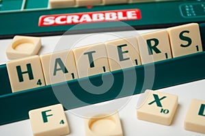 plastic letters on Scrabble board game forming the word : Haters