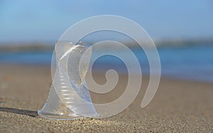 Plastic litter on the ocean shore, selective focus