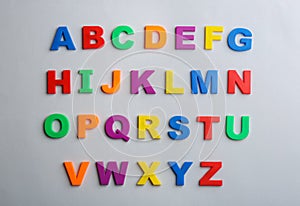 Plastic magnetic letters on grey background. Alphabetical order