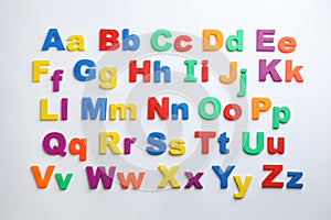 Plastic magnetic letters isolated on white, top view.