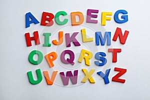 Plastic magnetic letters isolated on white, top view.