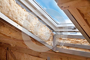 Plastic mansard or skylight window on attic with environmentally friendly and energy efficient thermal insulation rockwool