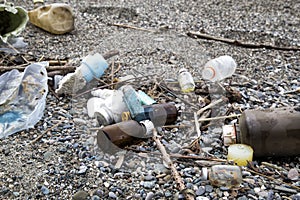 Plastic and medical waste materials at the beach.