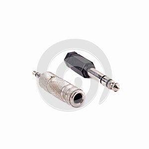 Plastic and metal audio Jack-to-minijack and minijack-to-Jack adapter isolated on a white background. Close up photo