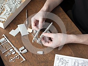 Plastic model builder is slapping a model together. Assembling the model of airplane