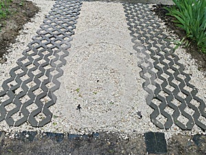 Plastic modules for arranging a car entrance on a background of decorative white stones