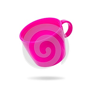 Plastic mug isolated on white background. Pink child cup for drink. Clipping paths object for your design