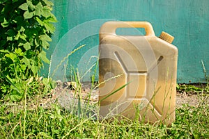 Plastic old vintage canister for liquid on the background of blu