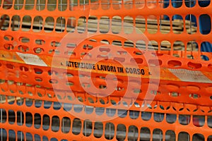 Plastic orange safety net to delimit the area of a road construc