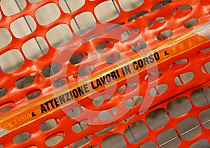 Plastic orange safety net with words ATTENZIONE LAVORI IN CORSO photo