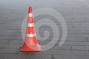 Plastic orange traffic cone on city street