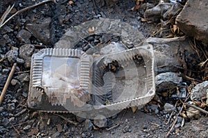 Plastic packaging lies on the ground, garbage on the street, environmental disaster