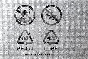 Plastic packaging symbols: warning to keep bags away from children, recycle icon, recyclable symbol 04 PE-LD