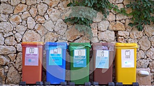 Plastic paper metal glass organic waste sorting. Different Colored Recycle Waste Bins outdoors. Separate waste