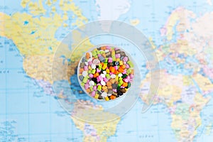 Plastic pellets on the background of the world map .The concept of Plastic pollution. The concept of world environment day.