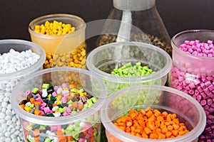 Plastic pellets. Dyes for plastic, polypropylene, polyethylene. Plastic granules in a measuring container and test tubes in the
