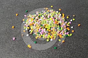 Plastic pellets. Dyes for plastic, polypropylene, polyethylene. Plastic granules on a stone background .Plastic pellets. Plastic