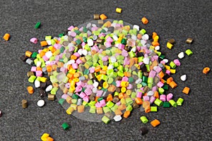 Plastic pellets. Dyes for plastic, polypropylene, polyethylene. Plastic granules on a stone background .Plastic pellets. Plastic