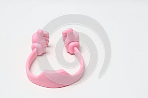 Plastic phone holder in the shape of two hands, thumbs up, pink.