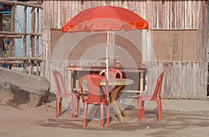 Plastic Picnic table with four seats with umbrella in outdoor of a street restaurant Cafe